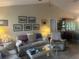 Comfortable living room with neutral tones, tile floors, and a collection of decorative items at 4027 Allure Ln, North Port, FL 34287