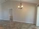 Inviting space with tile floors, neutral walls, and a traditional chandelier at 4027 Allure Ln, North Port, FL 34287