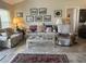 Comfortable living room area with neutral tones, including a sofa, chairs, and decorative rug at 4027 Allure Ln, North Port, FL 34287