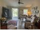 Comfortable living room featuring tile flooring, a ceiling fan, and an exit to the backyard at 4027 Allure Ln, North Port, FL 34287