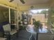 Cozy screened porch featuring outdoor seating, decor, and plenty of sunlight at 4027 Allure Ln, North Port, FL 34287