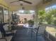 Cozy screened porch featuring outdoor seating, decor, and plenty of sunlight at 4027 Allure Ln, North Port, FL 34287