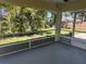 Screened in porch featuring gray flooring and backyard view at 4027 Allure Ln, North Port, FL 34287