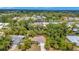 Aerial view showcases this home's proximity to mature trees, neighboring houses and scenic waterways at 4322 Concert St, Port Charlotte, FL 33948