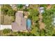 Aerial view of home with screened-in pool, lush landscaping, and well-maintained roof at 4322 Concert St, Port Charlotte, FL 33948