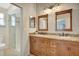 Bathroom with double sinks, granite countertops, glass shower, and decorative lighting at 4322 Concert St, Port Charlotte, FL 33948
