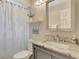 Bright bathroom with a shower-tub combo featuring a decorative shower curtain and a granite-topped vanity at 4322 Concert St, Port Charlotte, FL 33948