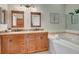 Bathroom with double sinks, granite countertops, jacuzzi tub, and decorative lighting at 4322 Concert St, Port Charlotte, FL 33948