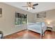 Cozy bedroom with hardwood floors and a large window overlooking a lush garden at 4322 Concert St, Port Charlotte, FL 33948