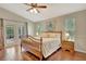 Spacious bedroom features wood floors, ceiling fan and outdoor access via French doors to a patio at 4322 Concert St, Port Charlotte, FL 33948