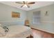Cozy bedroom with hardwood floors, chair, and a simple nautical themed decor at 4322 Concert St, Port Charlotte, FL 33948