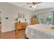 Bedroom boasts hardwood floors, access to the lanai, and a large window for plenty of natural light at 4322 Concert St, Port Charlotte, FL 33948