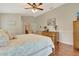 Bedroom boasts hardwood floors, a dresser, and a large window for plenty of natural light at 4322 Concert St, Port Charlotte, FL 33948