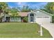Charming single-story home with lush landscaping, beautiful green lawn, and a two-car garage at 4322 Concert St, Port Charlotte, FL 33948