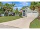 Lovely single-story home with mature palm trees, a well-kept lawn, and an attached two-car garage at 4322 Concert St, Port Charlotte, FL 33948