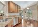 Kitchen with granite countertops, wooden cabinets, and stainless-steel appliances at 4322 Concert St, Port Charlotte, FL 33948