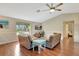 Inviting living room with hardwood floors, vaulted ceilings, and a large window with views of tropical foliage at 4322 Concert St, Port Charlotte, FL 33948