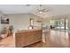 Open-concept living room featuring hardwood floors, vaulted ceilings, and sliding glass doors to lanai at 4322 Concert St, Port Charlotte, FL 33948