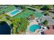 Aerial view of the community pool, tennis courts, and lush landscaping at 4325 46Th W Ave # 203, Bradenton, FL 34210