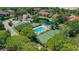 An aerial view showcasing community amenities, including pools, tennis courts, and a pond at 4325 46Th W Ave # 203, Bradenton, FL 34210