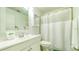 Clean and well-lit bathroom with a modern vanity, fresh towels, and shower with a white curtain at 4325 46Th W Ave # 203, Bradenton, FL 34210