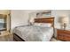 Comfortable bedroom showcasing a well-made bed, soft lighting, and a doorway to the ensuite bathroom at 4325 46Th W Ave # 203, Bradenton, FL 34210