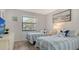 Serene bedroom featuring twin beds, a large window with blinds, and a calming decor at 4325 46Th W Ave # 203, Bradenton, FL 34210