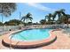 Sparkling community pool surrounded by lounge chairs and lush tropical landscaping at 4325 46Th W Ave # 203, Bradenton, FL 34210