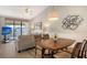 Open-concept dining area featuring a vaulted ceiling and modern lighting fixtures at 4325 46Th W Ave # 203, Bradenton, FL 34210