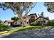 Well-maintained home exterior with mature trees, landscaping, and a driveway at 4325 46Th W Ave # 203, Bradenton, FL 34210