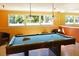 Game room features a pool table with overhead lighting and comfortable seating at 4325 46Th W Ave # 203, Bradenton, FL 34210