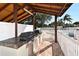 Outdoor grilling area under a wooden pavilion near pool featuring dual grills at 4325 46Th W Ave # 203, Bradenton, FL 34210
