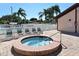 Community hot tub surrounded by lounge chairs and lush landscaping on a sunny day at 4325 46Th W Ave # 203, Bradenton, FL 34210