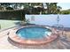 Community hot tub with brick trim and handrail near tennis courts at 4325 46Th W Ave # 203, Bradenton, FL 34210