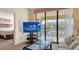 Bright living room with large sliding glass doors and a view of the bedroom at 4325 46Th W Ave # 203, Bradenton, FL 34210