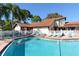 Large community swimming pool, surrounded by lounge chairs and lush landscaping at 4325 46Th W Ave # 203, Bradenton, FL 34210