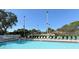 Outdoor community pool with chairs around the edge at 4325 46Th W Ave # 203, Bradenton, FL 34210