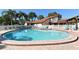 Large community swimming pool, surrounded by lounge chairs and lush landscaping at 4325 46Th W Ave # 203, Bradenton, FL 34210