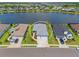 Aerial view showcasing the home's positioning amidst well-manicured lawns and a serene lake backdrop at 4407 Big Woods Way, Parrish, FL 34219