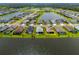 An aerial shot reveals the community's layout, featuring homes surrounding scenic lakes and lush landscaping at 4407 Big Woods Way, Parrish, FL 34219