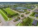 Aerial view of Canoe Creek community featuring winding roads, a lake, pool, clubhouse and green spaces at 4407 Big Woods Way, Parrish, FL 34219