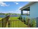 Lush backyard with lake view and metal fence, providing a serene and private outdoor space at 4407 Big Woods Way, Parrish, FL 34219