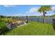 Enjoy the landscaped backyard with seating, a fireplace, and beautiful lake views at 4407 Big Woods Way, Parrish, FL 34219