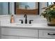 Close-up of bathroom sink with stone countertops and modern black faucet at 4407 Big Woods Way, Parrish, FL 34219