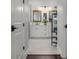 Bathroom featuring white cabinets, dual mirrors, and modern fixtures at 4407 Big Woods Way, Parrish, FL 34219