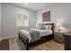 Cozy bedroom with natural light, plantation shutters, wood accent furniture, neutral decor, and rug at 4407 Big Woods Way, Parrish, FL 34219
