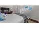 Comfortable bedroom with TV, neutral color scheme, decorative pillows, throw blanket and hardwood floors at 4407 Big Woods Way, Parrish, FL 34219