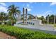 The Canoe Creek entrance sign surrounded by lush green hedges and palm trees at 4407 Big Woods Way, Parrish, FL 34219