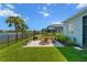 Beautiful home exterior showcasing the landscaped yard and outdoor entertainment area at 4407 Big Woods Way, Parrish, FL 34219