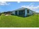 Exterior view of the house shows the expansive yard, lanai, patio and waterfront at 4407 Big Woods Way, Parrish, FL 34219